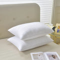 White cotton satin stripe pillow with feather cotton filler, shown in low, medium, and high loft options.