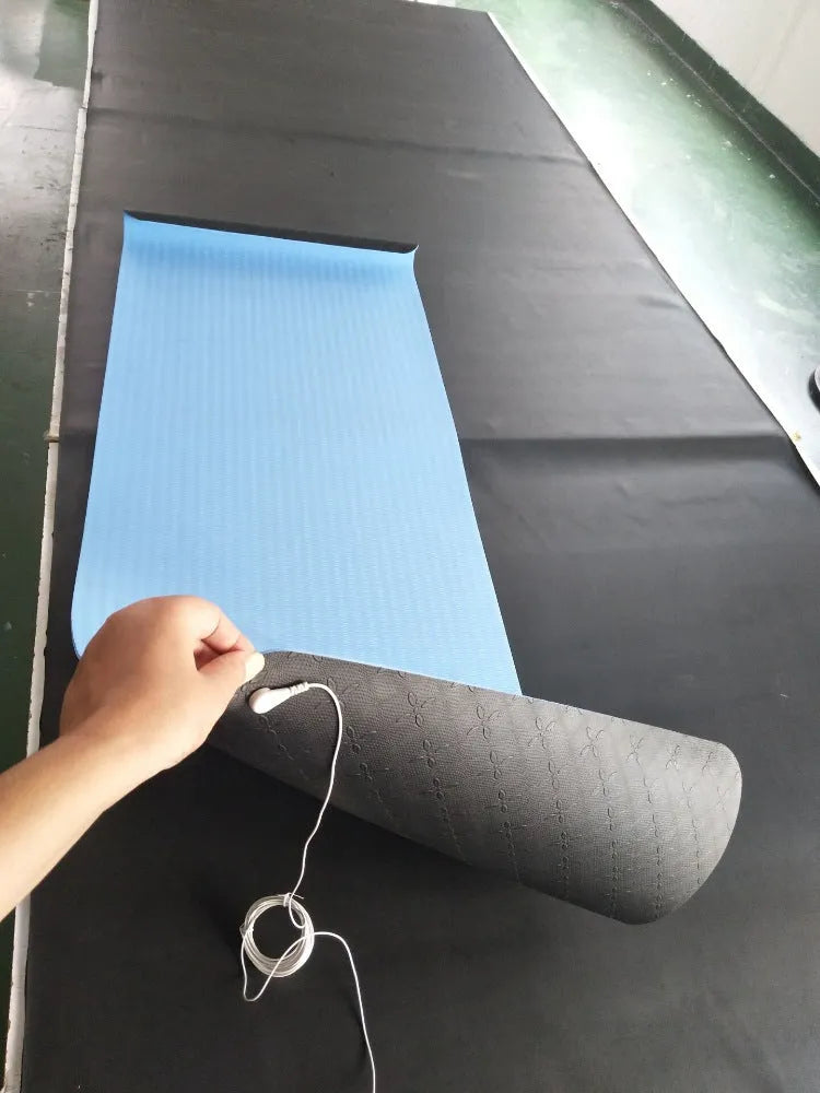 Blue conductive yoga mat with floral pattern and grounding wire for earthing exercises
