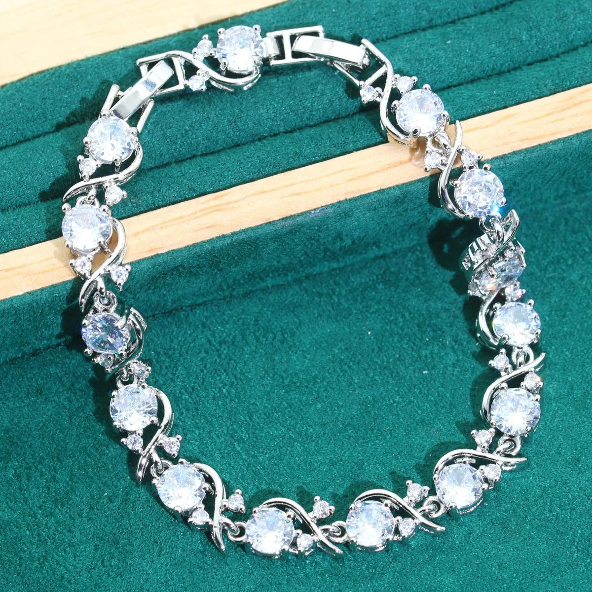 Bridal zircon jewellery four-piece set showing necklace, bracelet, earrings and ring in alloy with water wave chain