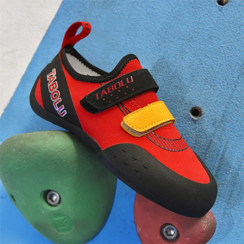 Black and red beginner rock climbing shoes with Velcro closure and rubber outsole