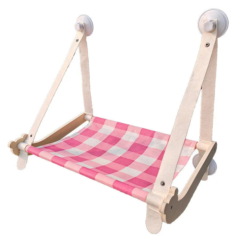 Wooden cat window hammock with suction cups on a glass window