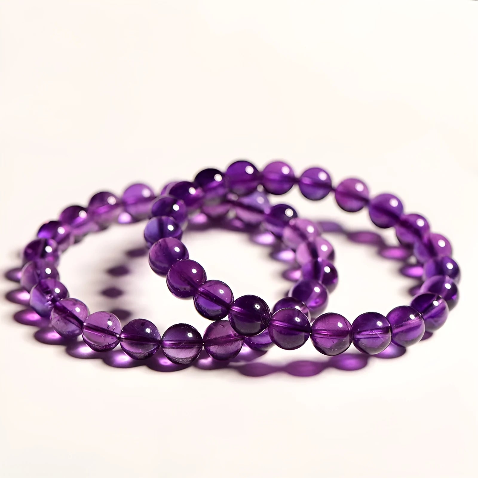 Natural amethyst bracelet with scattered Uruguay beads in jiuya colour, shown in selectable grades and sizes.