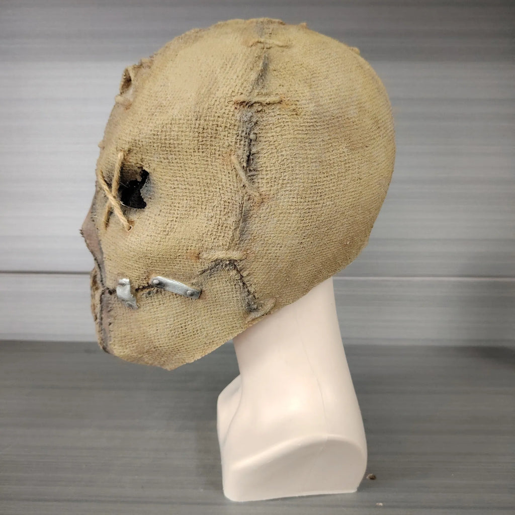 Latex Halloween horror mask with scar skull design, shown as a full head cover.