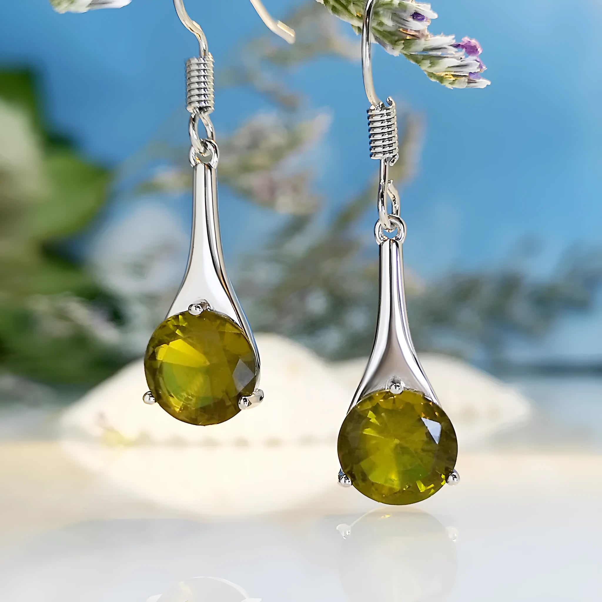 A pair of olive green retro-style drop earrings made from alloy on a white background.