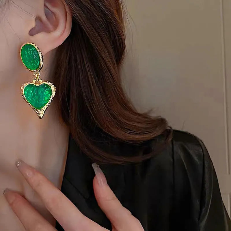 Silver needle pleated oval love heart alloy stud earrings in purple, red, green, and yellow and white colours.