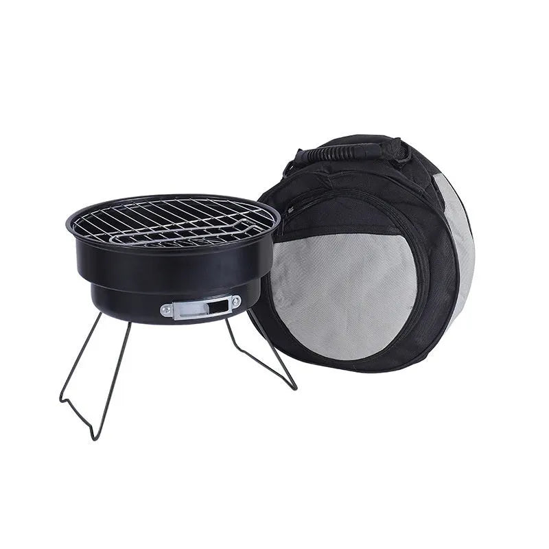 Small round metal folding camping stove with grill mesh and legs, packed in a carry bag.