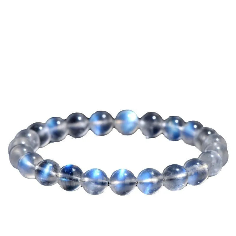 Natural blue moonlight cream body crystal bracelet on wrist, showing single strand of polished beads.