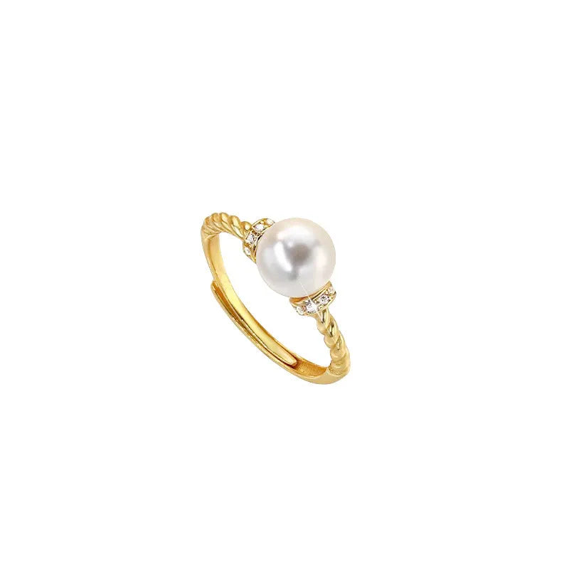 Adjustable antique twist design copper ring with pearl inlay in gold colour.