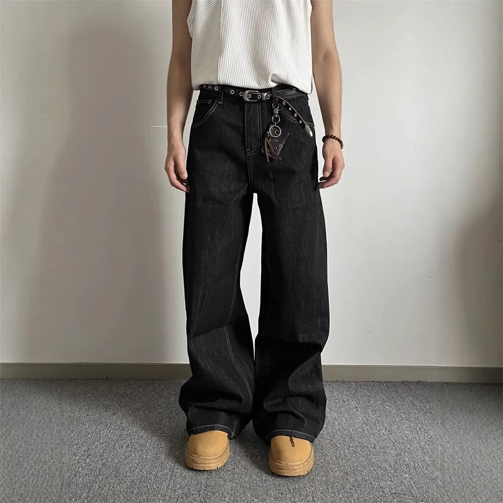 Black retro-style loose wide-leg straight-leg jeans on a hanger, showing mid-waist and zip fly.