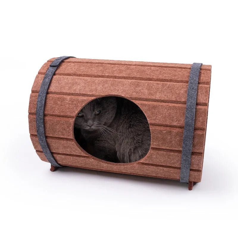 DIY assembled wine barrel shaped cat bed made from grey felt pieces with binding straps.