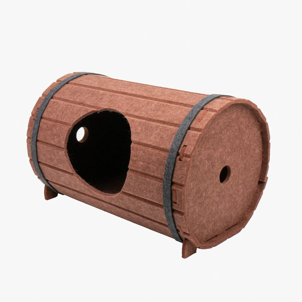 DIY assembled wine barrel shaped cat bed made from grey felt pieces with binding straps.