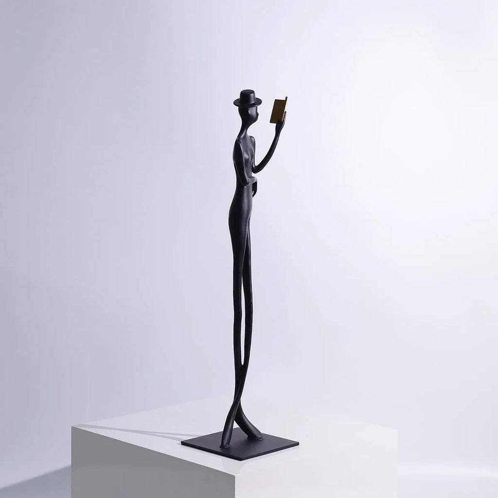 Black aluminium desktop sculpture of woman reading in modern style