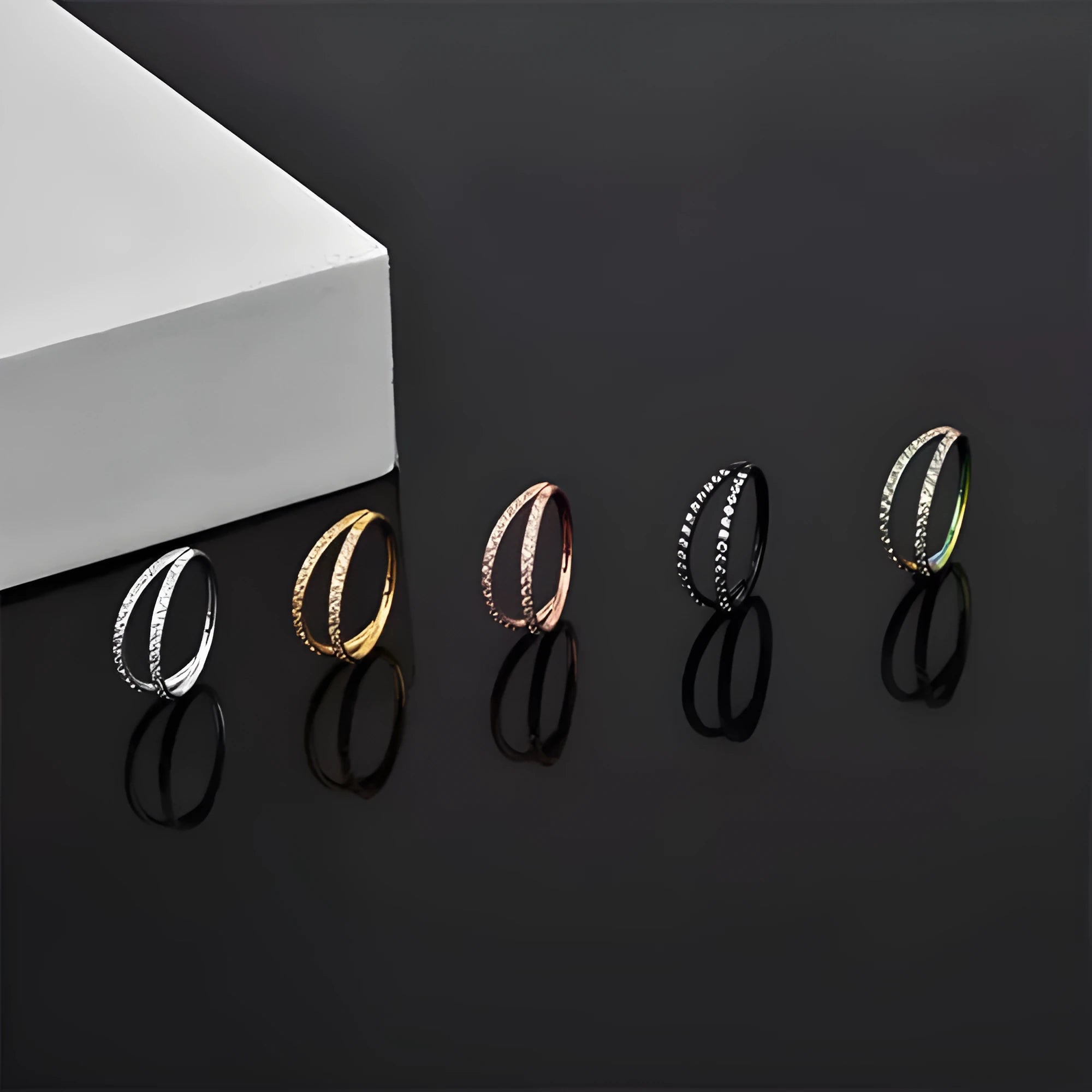 G23 titanium alloy nose ring with zircon stone in gold and steel colours showing 1.2mm gauge stud