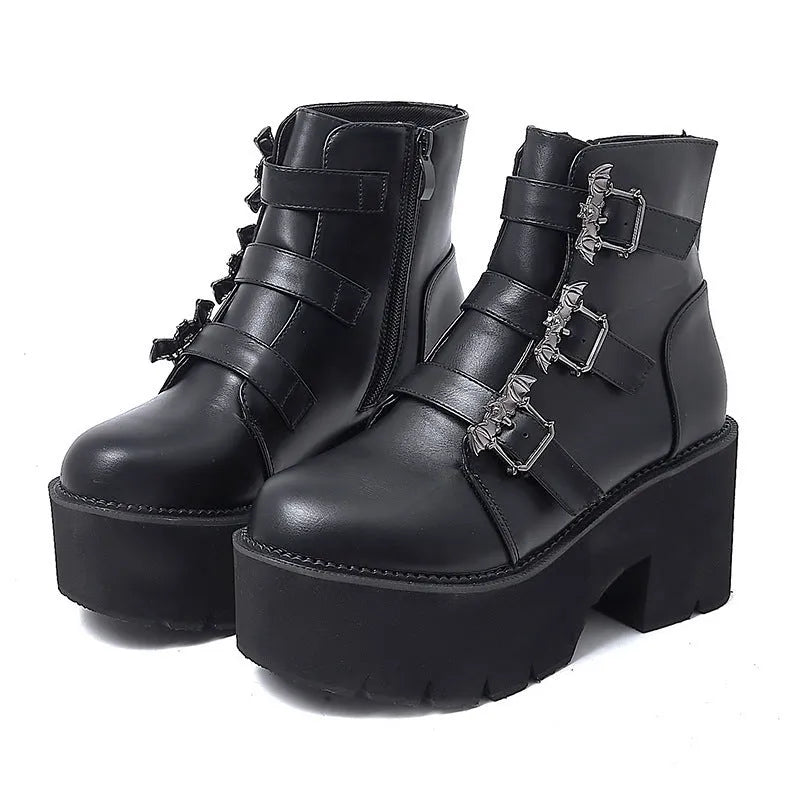 Black women's punk boots with bat buckle, side zip, thick heel, and round toe.