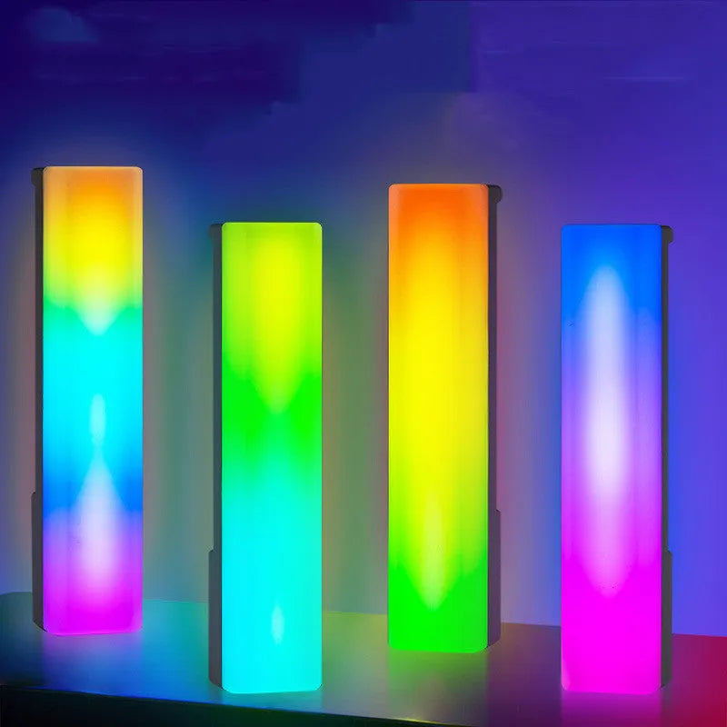 Black and white 3D RGB music rhythm ambiance lamp on a table with USB cable.