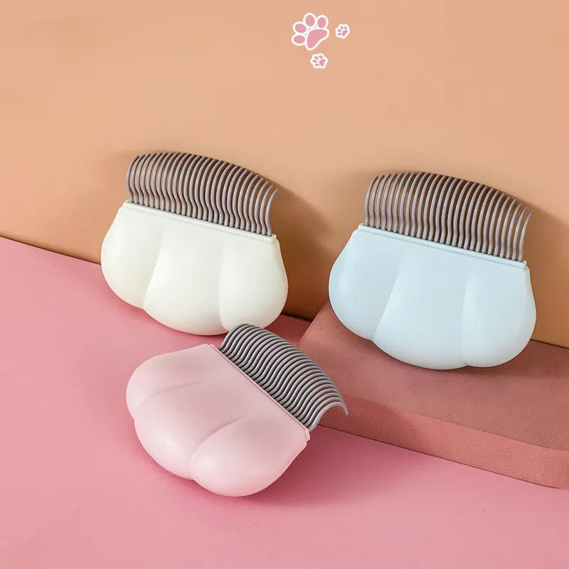 Paw Soft pet deshedding brush with ergonomic handle in blue, pink or white colour options.