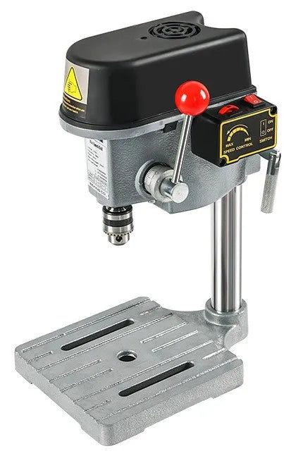 Bench-mounted drilling and milling machine with motor, chuck, and adjustable work table.