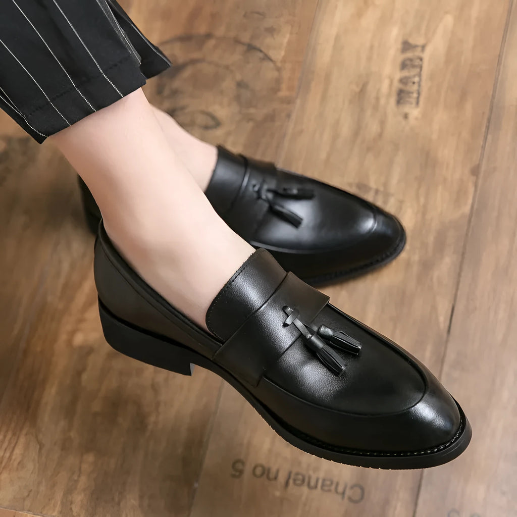 Men's black slip-on business casual leather shoes with tassel detail and rubber sole
