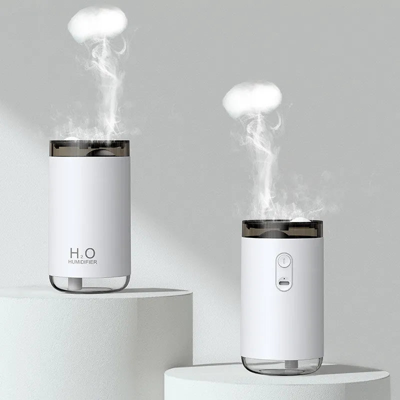 Mini USB jellyfish humidifier with warm night light in white, showing smoke-ring mist output