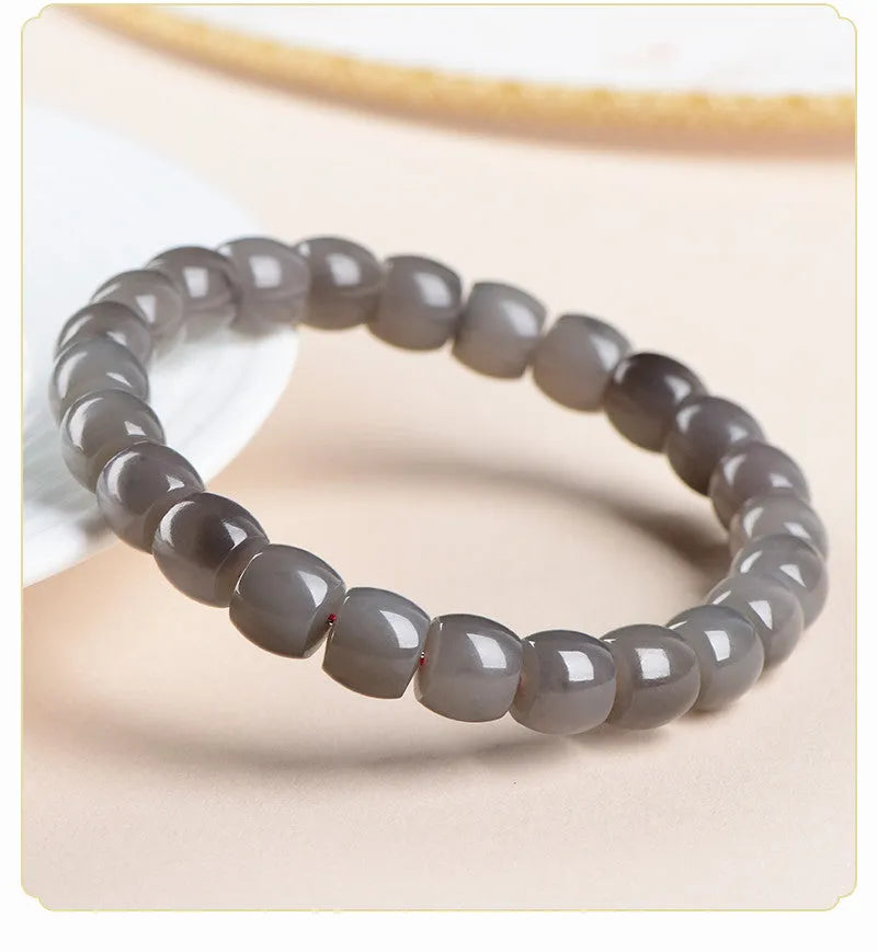 Natural smokey violet Hetian jade straight cut bead bracelet on a wrist