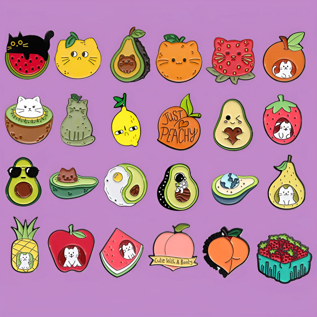 Colourful cartoon fruit design metal letter brooch on a fabric background.