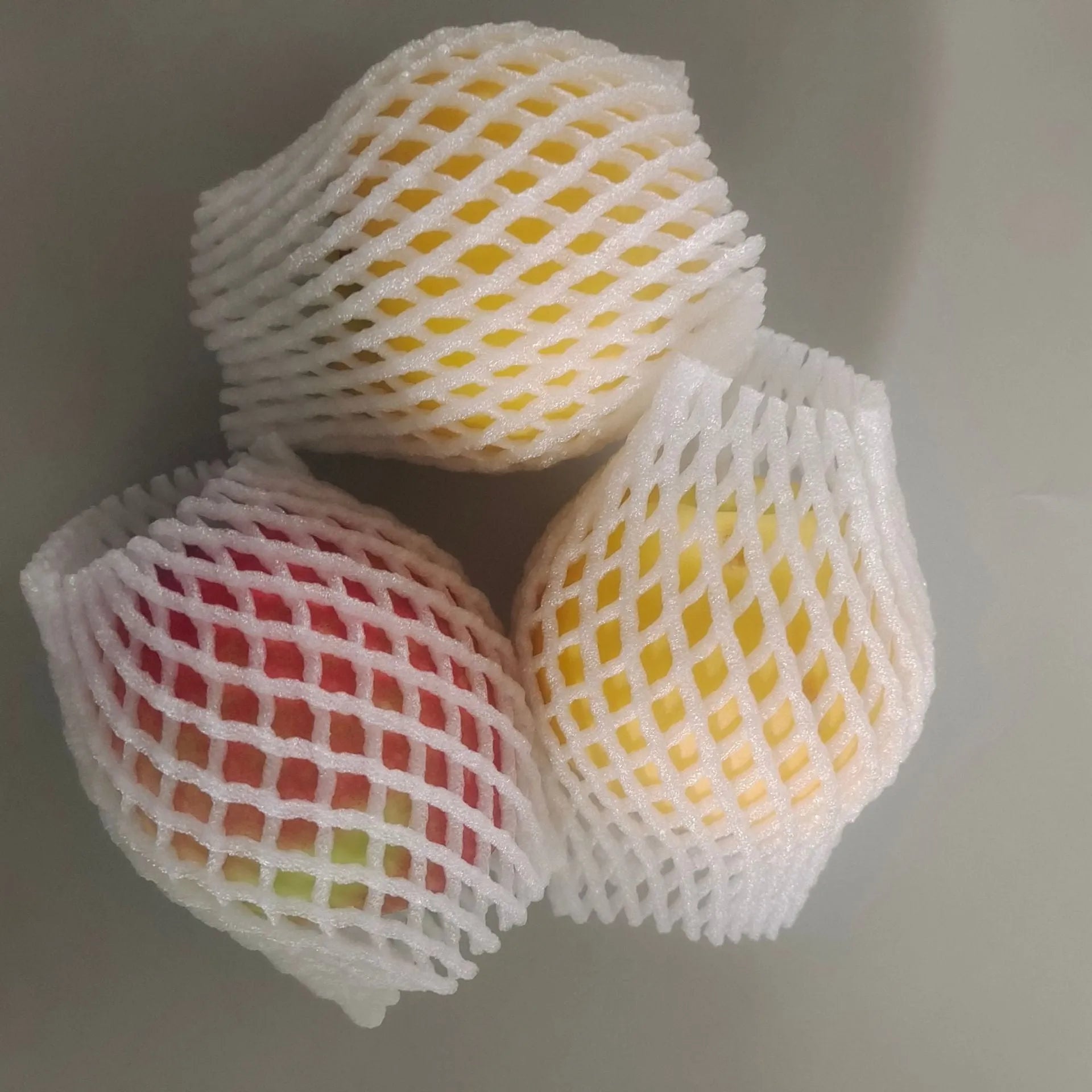 White foam net shockproof protective case for fruit, shown with sizing options.
