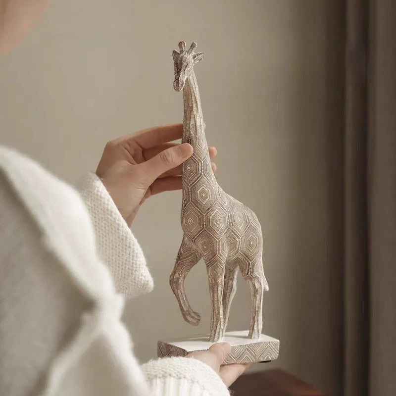 Wood colour synthetic resin giraffe decorative figure ornament on a shelf.