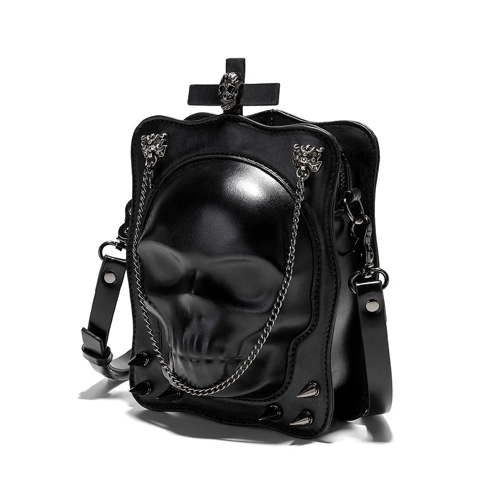Black mini skull shoulder bag with 3D embossed design, chain strap, and vertical square shape for Gothic fashion.
