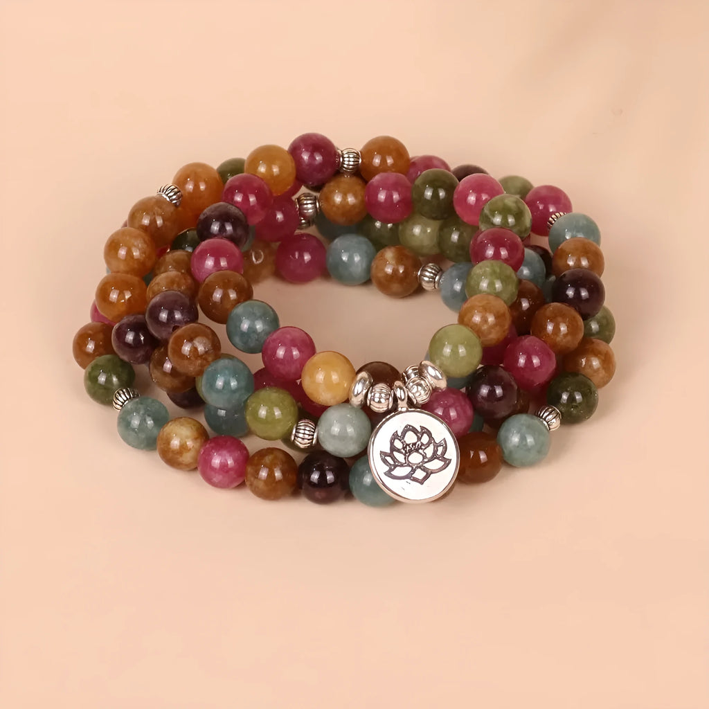 108 bead multi-layer bracelet with lotus charm in tourmaline colour on wrist
