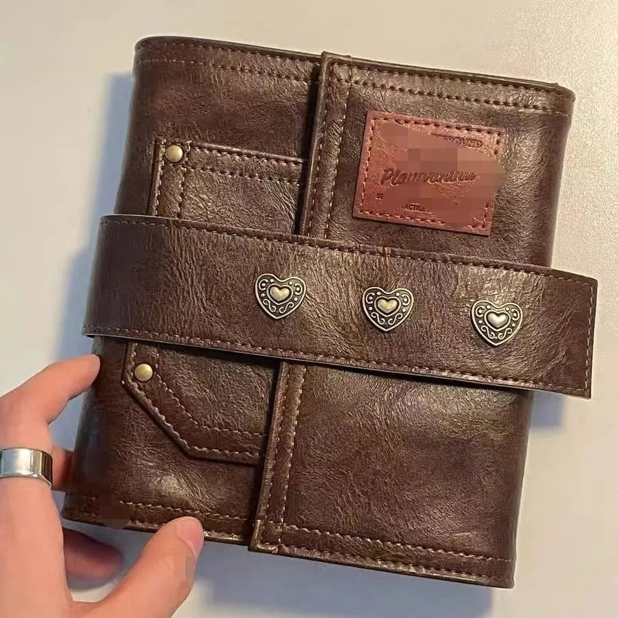 Brown retro-style A7 notebook with a leather buckle design and loose-leaf binding