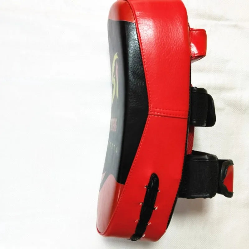 Black square boxing training pad with red trim, showing back with double buckle straps.