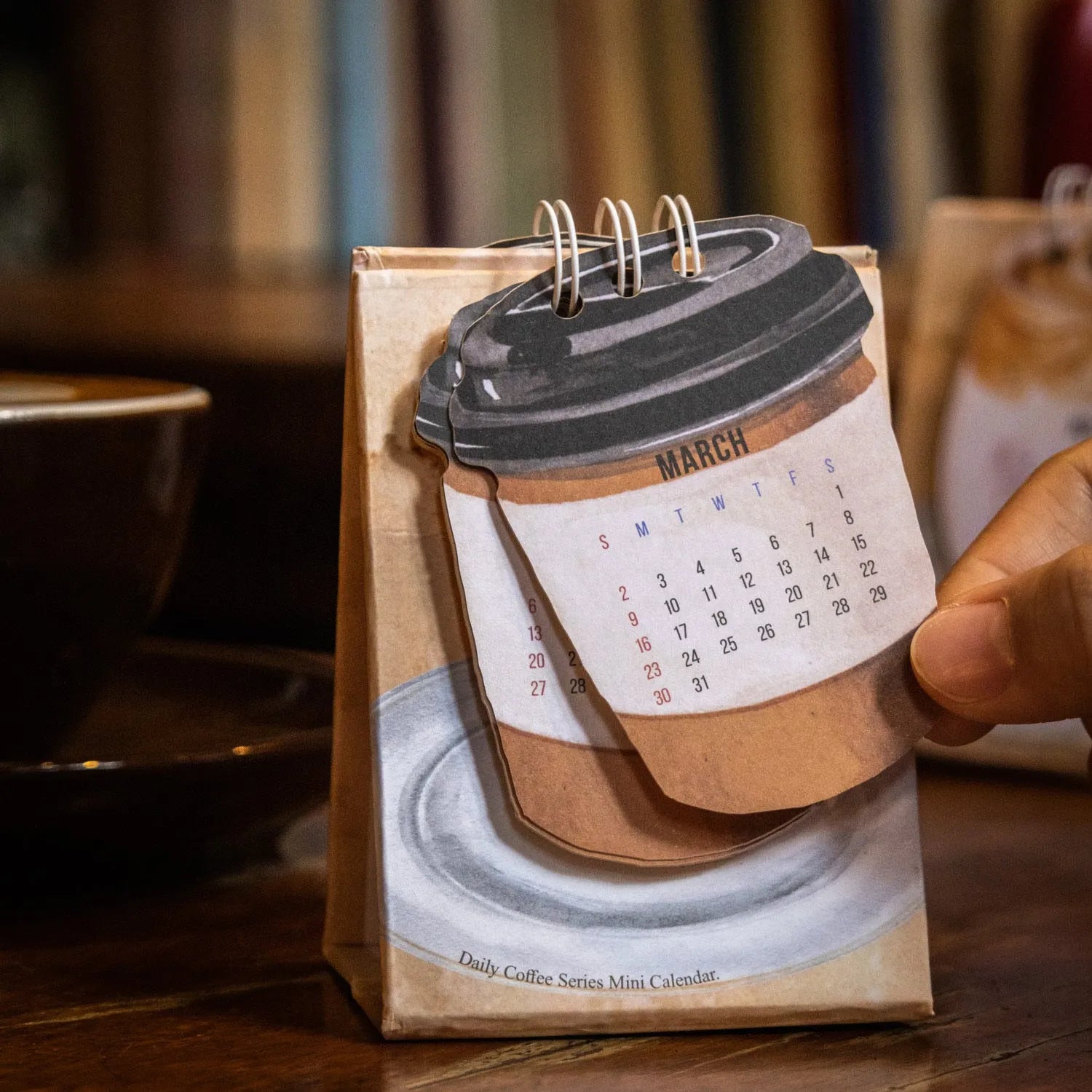 Mini 2025 desk calendar with simple modern design on a desk.