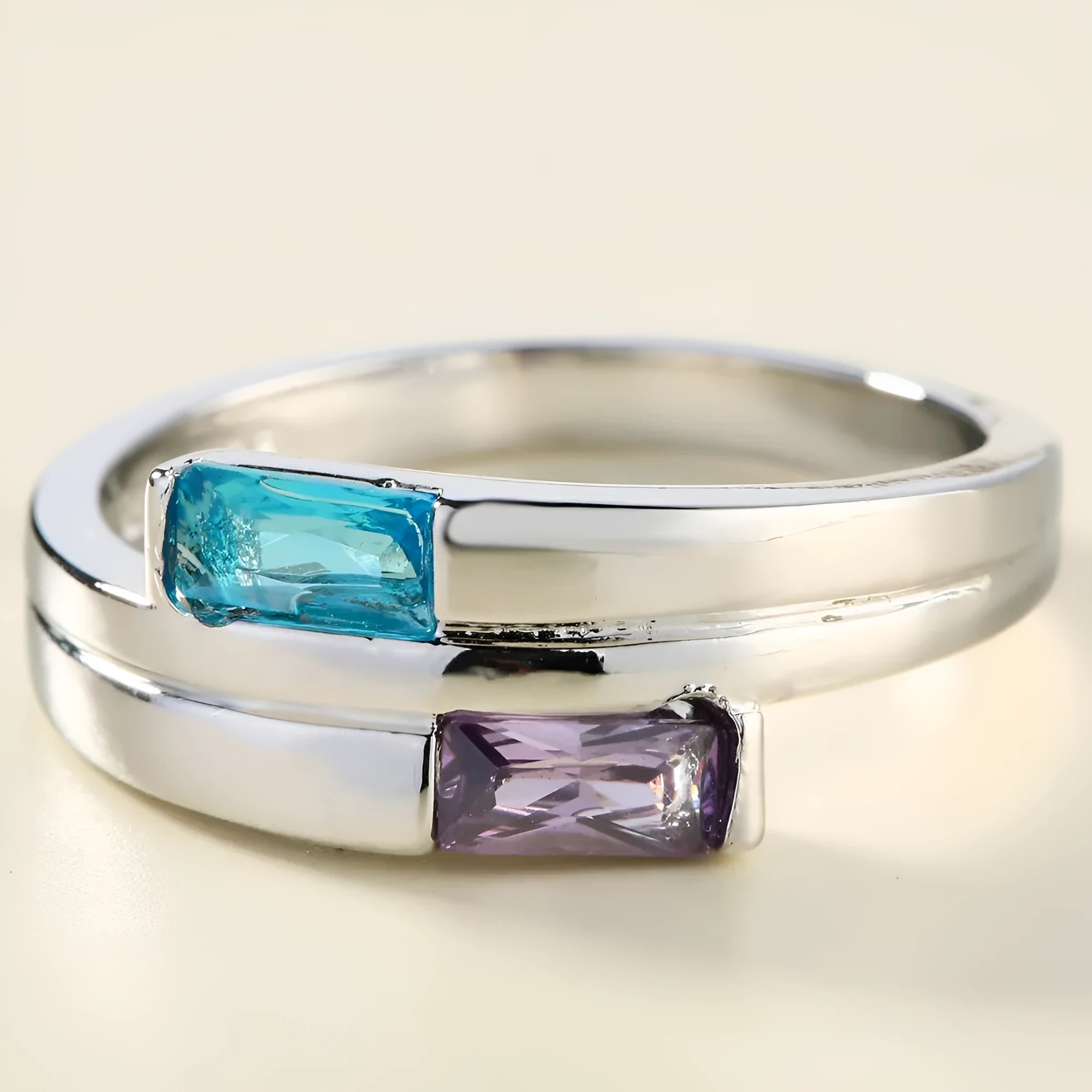 Silver-coloured copper ring with a central inlaid zircon stone, shown on a finger.