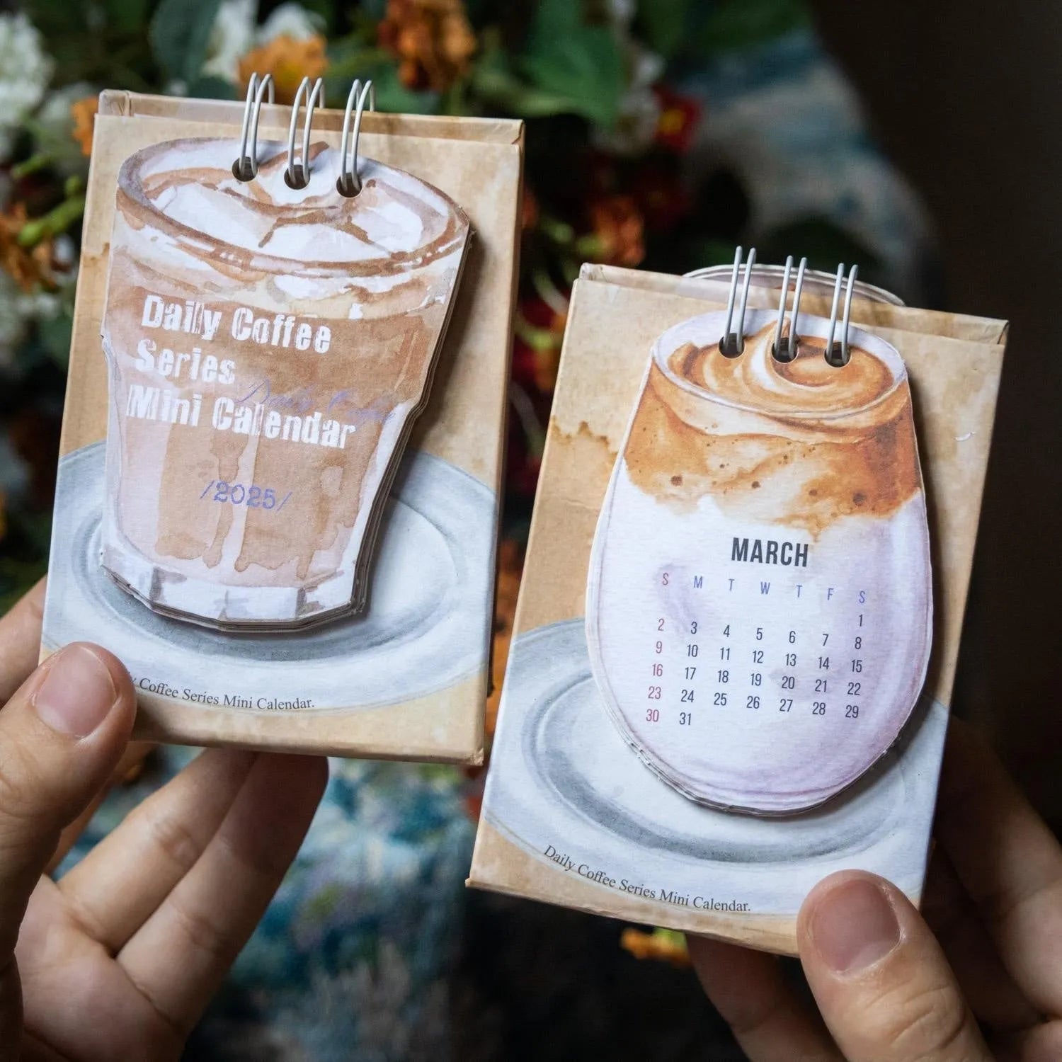 Mini 2025 desk calendar with simple modern design on a desk.