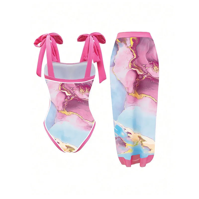 Pink one-piece printed sheath swimsuit for women with sun protection and matching skirt for beach or pool