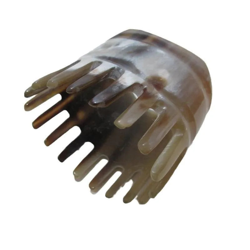 White buffalo horn comb with wide teeth and pointed tips for scalp massage and hair care