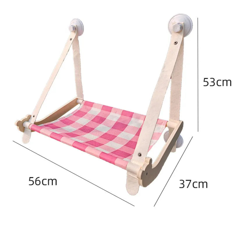 Wooden cat window hammock with suction cups on a glass window
