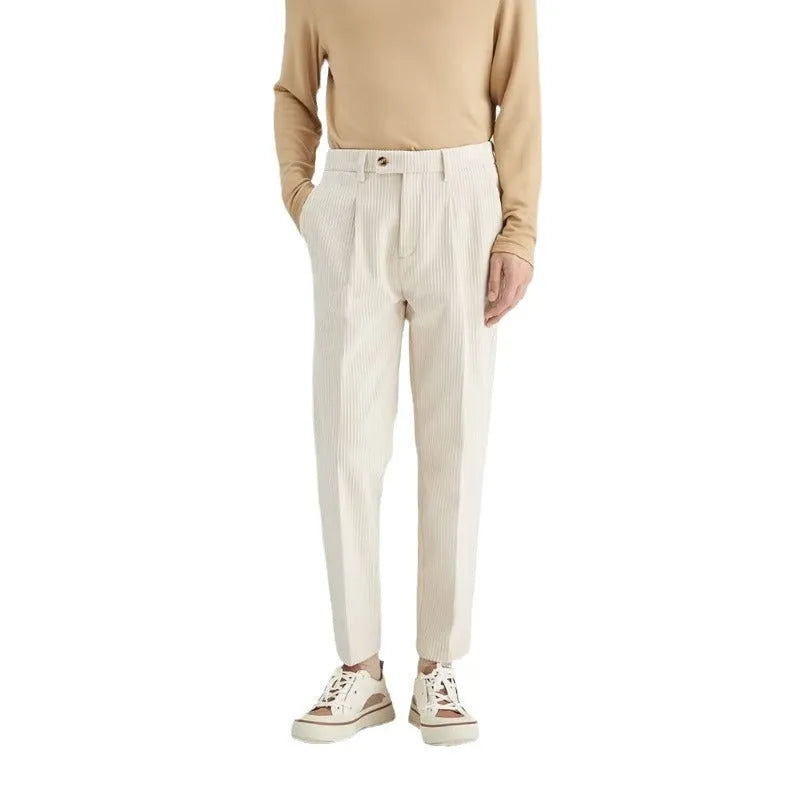 Men's straight-leg corduroy trousers in beige on a hanger, showing the textured fabric and mid-waist design.