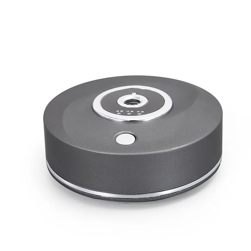 White plastic car aromatherapy diffuser with USB cable and anti-slip pad on a car dashboard.