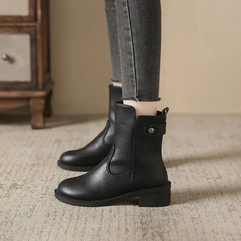 Black women's ankle boots with a side zipper, round toe, and a low rubber sole