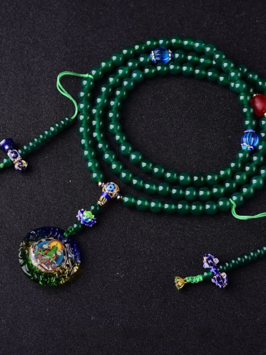 Handmade natural green agate Thangka pendant multi-circle bracelet on wrist.