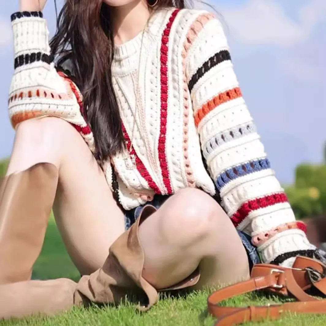 Women's rainbow striped batwing sleeve pullover sweater with a loose fit and round neck.