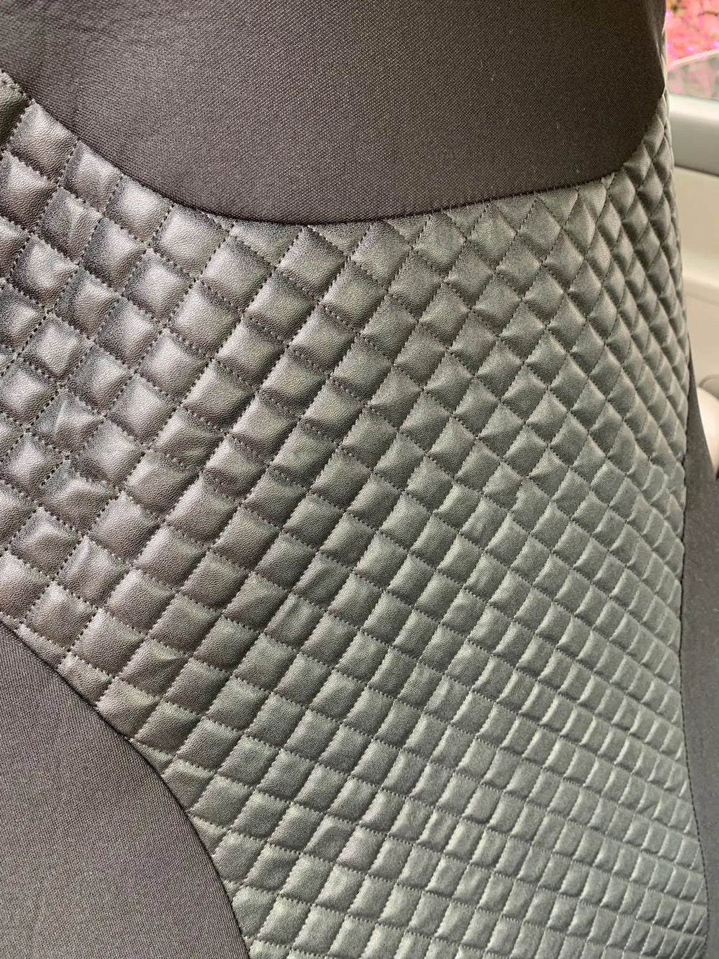 Black quilted universal car seat cover made from PU and polyester fabric.