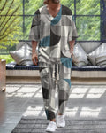 Women's light grey cropped sleeve V-neck jacket and trousers suit set laid flat.