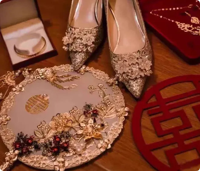 Champagne coloured pointed toe wedding heels with rhinestone floral detail on a fine heel.