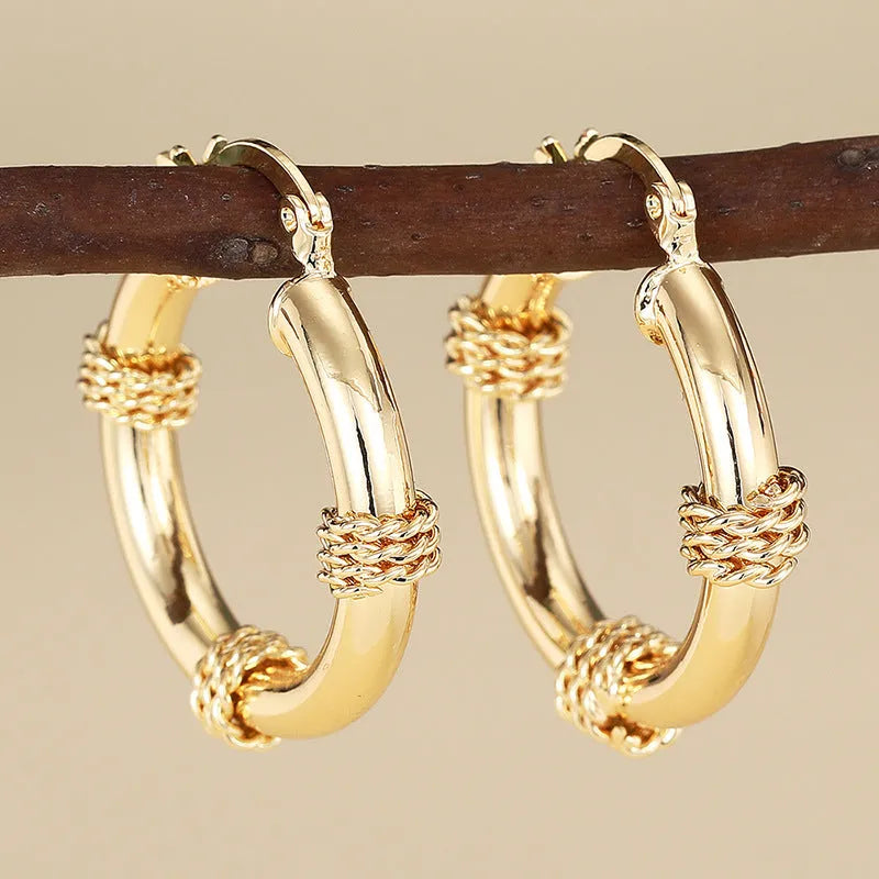 Geometric copper earrings in golden colours with ring and line elements for women