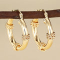 Geometric copper earrings in golden colours with ring and line elements for women