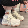 Women's green patent leather platform sneakers with round toe and lace-up front on a rubber sole.