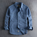 Men's light blue British retro style cotton cardigan shirt with long sleeves on a hanger.