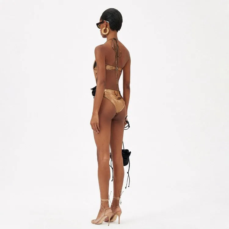 Gold coloured halter neck one piece swimsuit with a handmade hollow out flower design on the front.